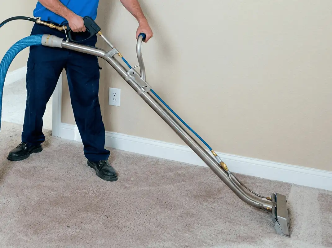 Professional operating a liquid removal machine on a carpeted floor in Shreveport, LA
