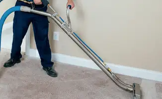 Professional operating a liquid removal machine on a carpeted floor in Shreveport, LA